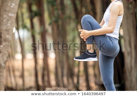 Сток-фото: Young Sports Woman Standing Outdoors Make Stretching Exercises Listening Music With Earphones