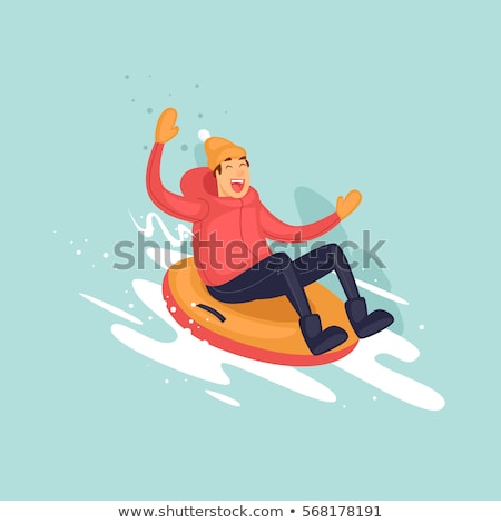 Foto stock: Happy Young Man Sliding Down Hill On Snow Tube