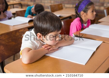 Zdjęcia stock: High Angle View Of A Mixed  Race Sad School Girl Sitting On Basketball And Looking At The Camera Whi