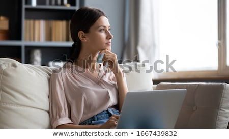 Foto d'archivio: Young Woman Working On A Laptop And Looking Sadness