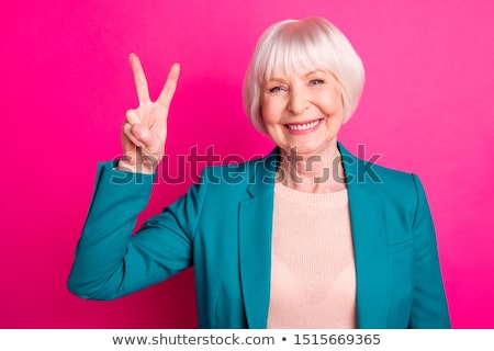 Stock photo: Young Woman Showing Peace Sign With Her Hands