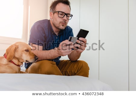 Stok fotoğraf: Man And Dog At A Pay Phone