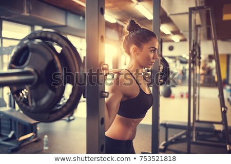 ストックフォト: Fitness Woman Doing Barbell Squats In A Gym