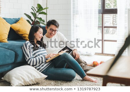 Stock fotó: Loving Young Couple Reading A Book In The Room