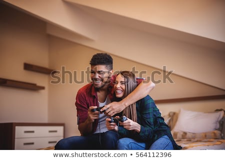 [[stock_photo]]: Young Couple Playing A Games Console