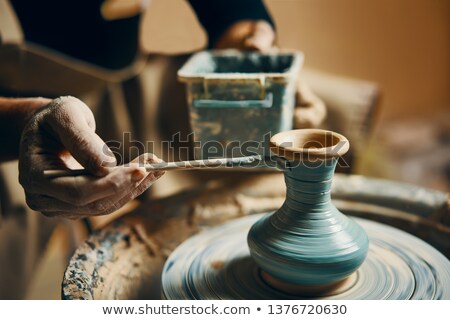 Stock photo: Potter Painting Products In A Pottery