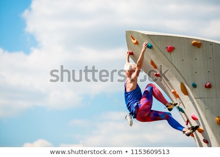 Stock photo: Sportswoman Preparing For Climbing Wall