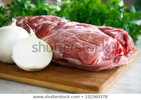 Foto stock: Slice Of Raw Beef Sirlion Steak On Wooden Chopping Board With Tomatoesgarlic And Asparagus Tips