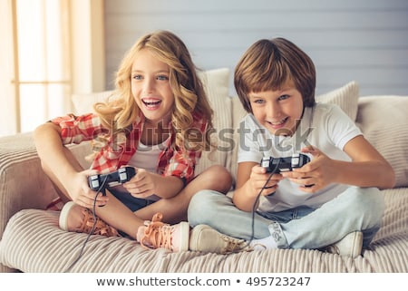 Foto d'archivio: Brother And Sister Playing Video Game