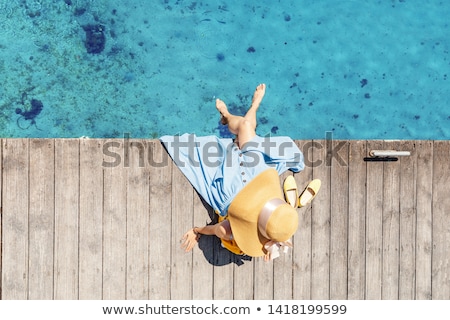 Foto d'archivio: Woman With A Backpack Enjoys A View Of The Ocean Coast Near Azen