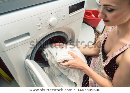 Stockfoto: Woman Homemaker Operating The Washing Machine