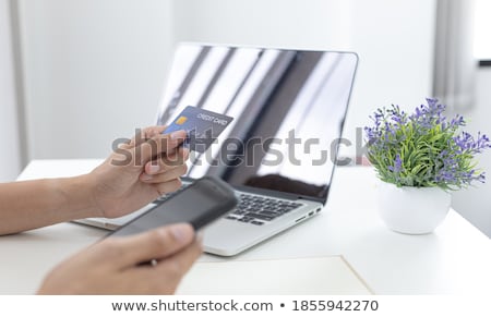 Foto stock: Man Using Smart Phone And Creditdebit Card Register Payments On