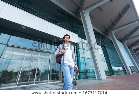 Stock fotó: Outdoor Shot Of Adult Man Returns From Business Trip Goes To Car With Suitcase Wears Medical Mask