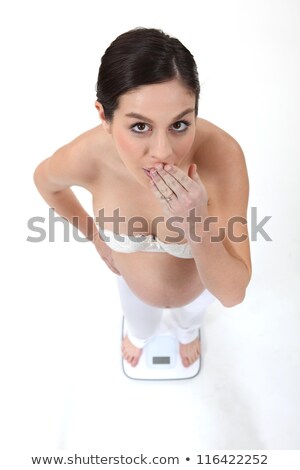 Stock fotó: Surprised Pregnant Woman On A Balance