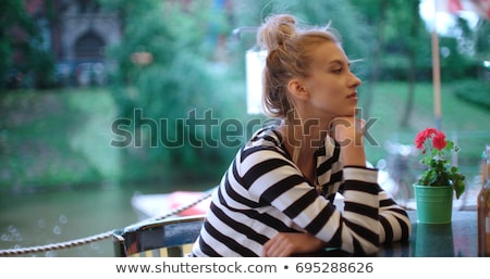 Сток-фото: Sad Bored Young Woman Sitting At The Table In Cafe