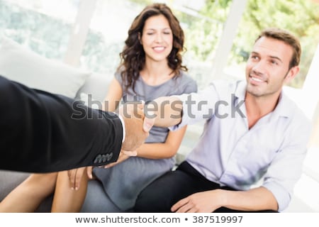 Stock fotó: Real Estate Agent Shaking Hands With Couple In Front Of House