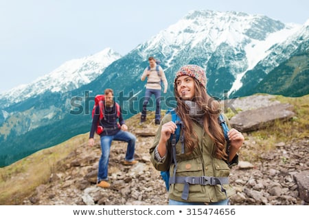 Foto d'archivio: Group Of Friends With Backpacks Over Mountains