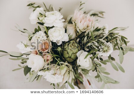 Stockfoto: Wedding Bouquet With White Flowers Roses Greens And Ribbons On The Chair