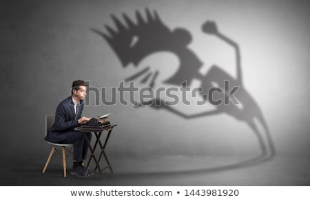 Stock photo: Man Working And He Is Afraid Of A Yelling Shadow