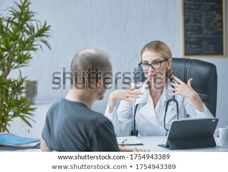 Stock fotó: Doctor Explaining Something To Nurse