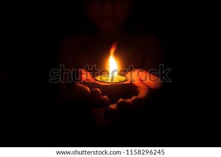 Stock photo: Man Lights A Candle In The Church