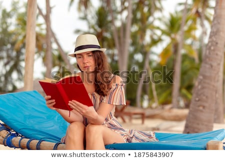 Foto stock: Woman Sitting On The Palm Tree Over The Sea