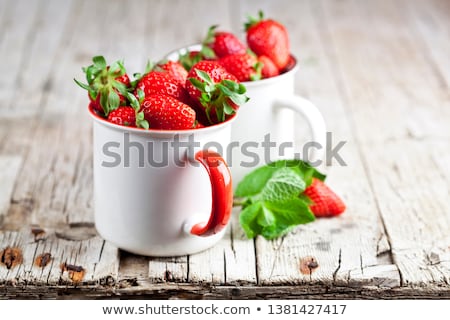 Stock photo: Organic Red Strawberries In Two White Ceramic Cups And Mint Leav