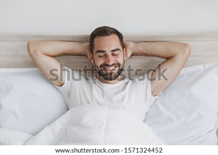 Foto stock: Man Lying On Bed Awake