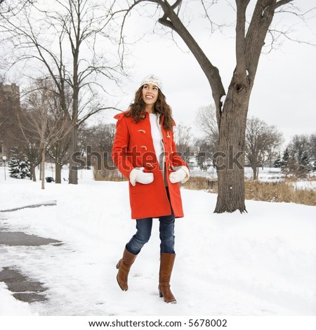 Young Woman Walking Down Snow Covered Street Stock fotó © iofoto