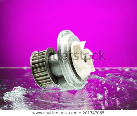 [[stock_photo]]: Auto Parts Engine Cooling Pump In Spurts Of Water On Purple Bac