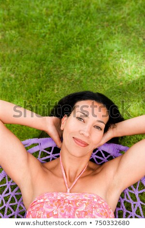 Сток-фото: Smily Woman Relaxing In A Swing Chair