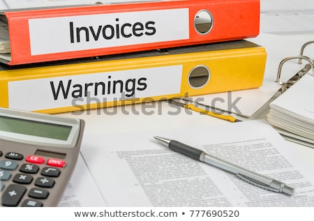 Foto stock: Folders With The Label Invoices And Warnings