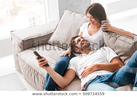 Stok fotoğraf: Young Couple Relaxing On Sofa