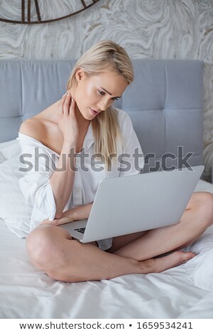 Zdjęcia stock: Beatutiful Woman In Mens Elegant White Shirt Sitting In Bed With Laptop