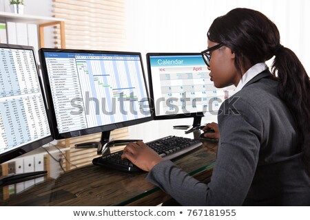 Сток-фото: African Businesswoman Analyzing Gantt Chart On Computer