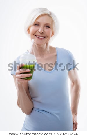 Сток-фото: Portrait Of Mature Woman Holding A Glass Of Juice