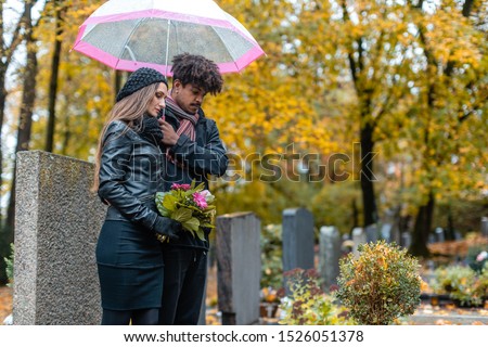 Stok fotoğraf: Couple In Grief On A Cemetery In Fall