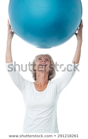 Woman Holding Up An Exercise Ball Foto stock © stockyimages