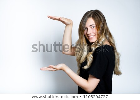 ストックフォト: Smiling Young Woman Holding Out Her Palms