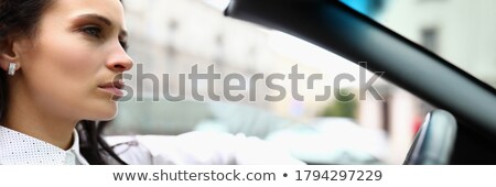 Stock photo: Young Beautiful Woman Sitting In A Convertible And Is Going To S