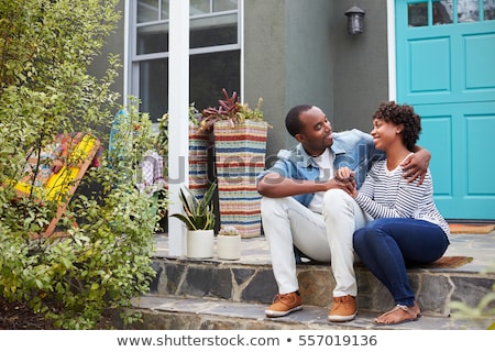 Foto stock: Happy Young Couple In Front Of Front Door Of New House