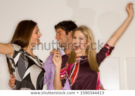 ストックフォト: Three Women Dancing With Mp3 Players