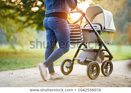 Foto stock: Woman With A Pram On Spring Walk
