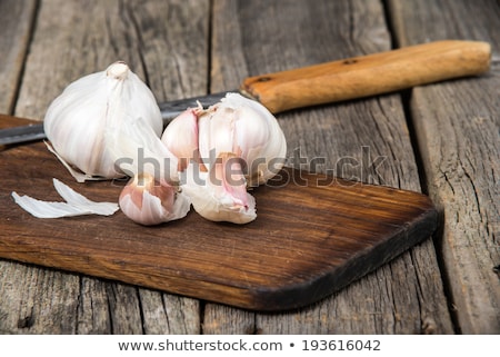 [[stock_photo]]: Garlic Cloves With Knife