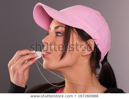 [[stock_photo]]: Attractive Brunette Female Blows Whistle Pink Ball Cap Whistlebl