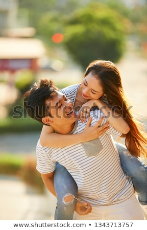 Foto stock: Man Giving His Pretty Girlfriend A Piggy Back