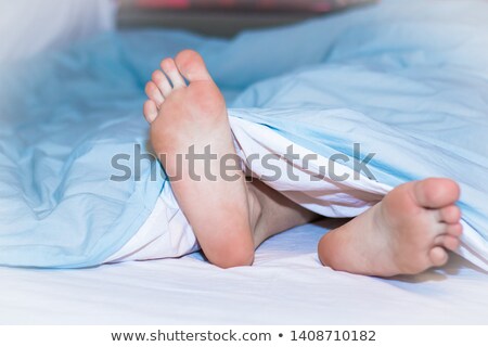 Zdjęcia stock: Female Bare Feet Under The Blanket
