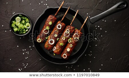 Stock foto: Barbecued Turkey Kebab Decorated With Fresh Onion