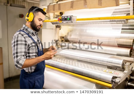 Young Serious Quality Control Engineer Using Tablet To Check Parameters 商業照片 © Pressmaster