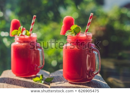 ストックフォト: Healthy Watermelon Smoothie With Mint A Piece Of Watermelon Hearts And A Striped Straw On A Wood B